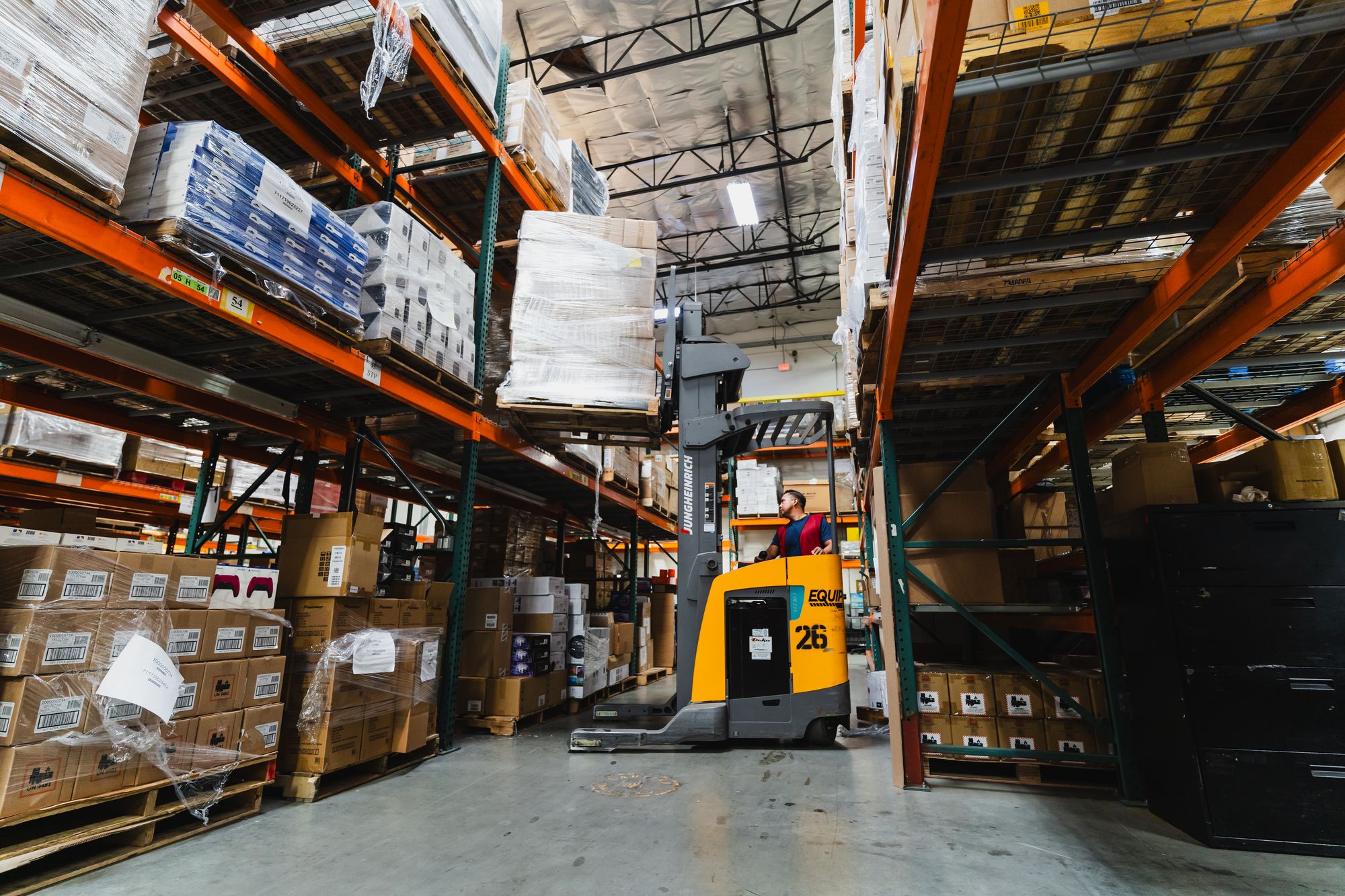 Forklifts working the pallet racks in the warehouse